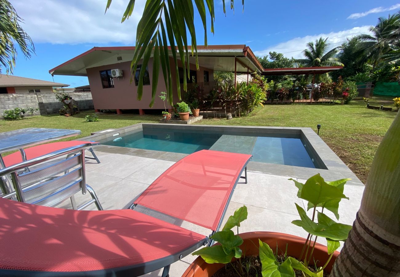 View of the pool, bungalow and garden